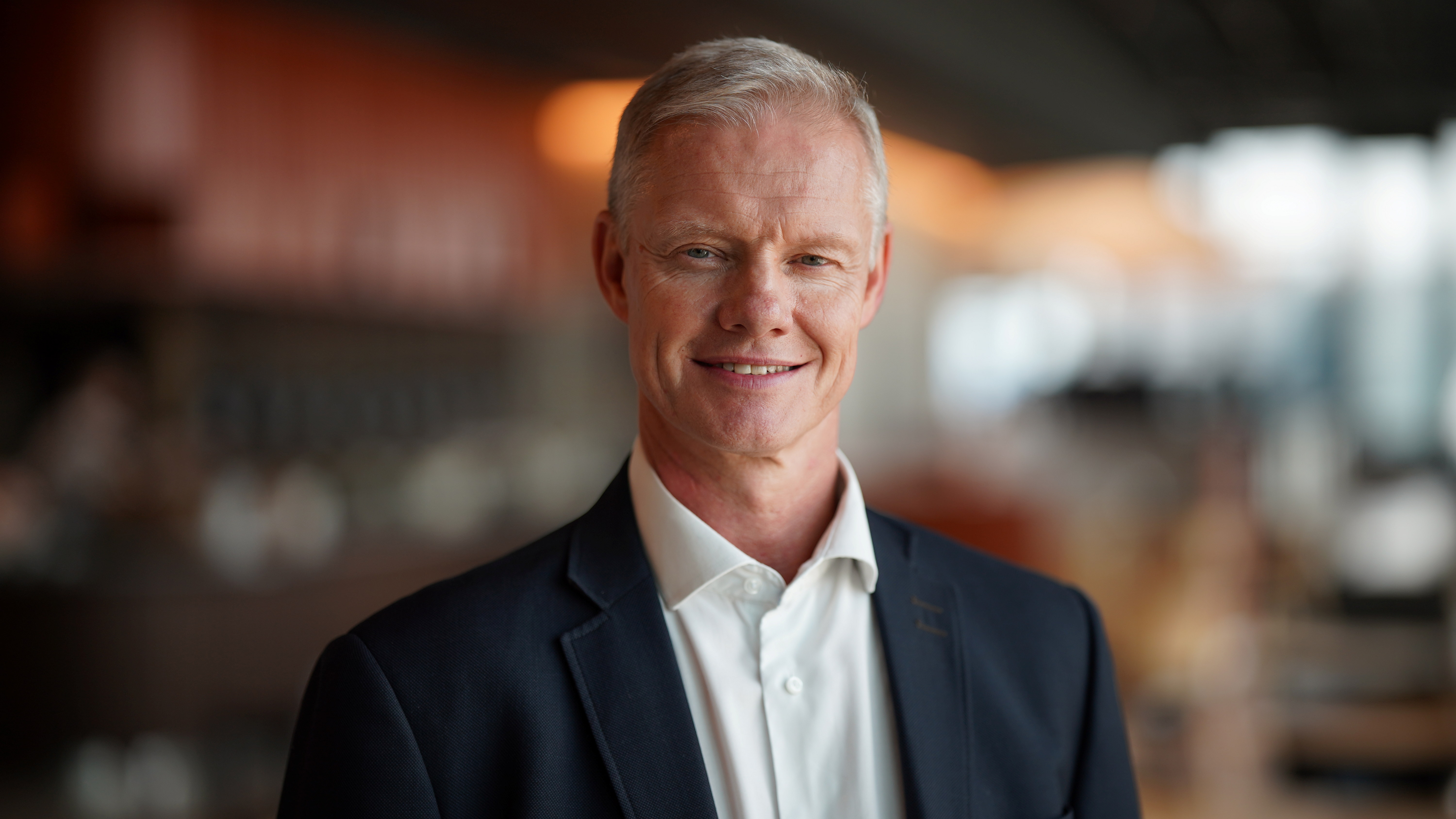 En mann smiler til kamera