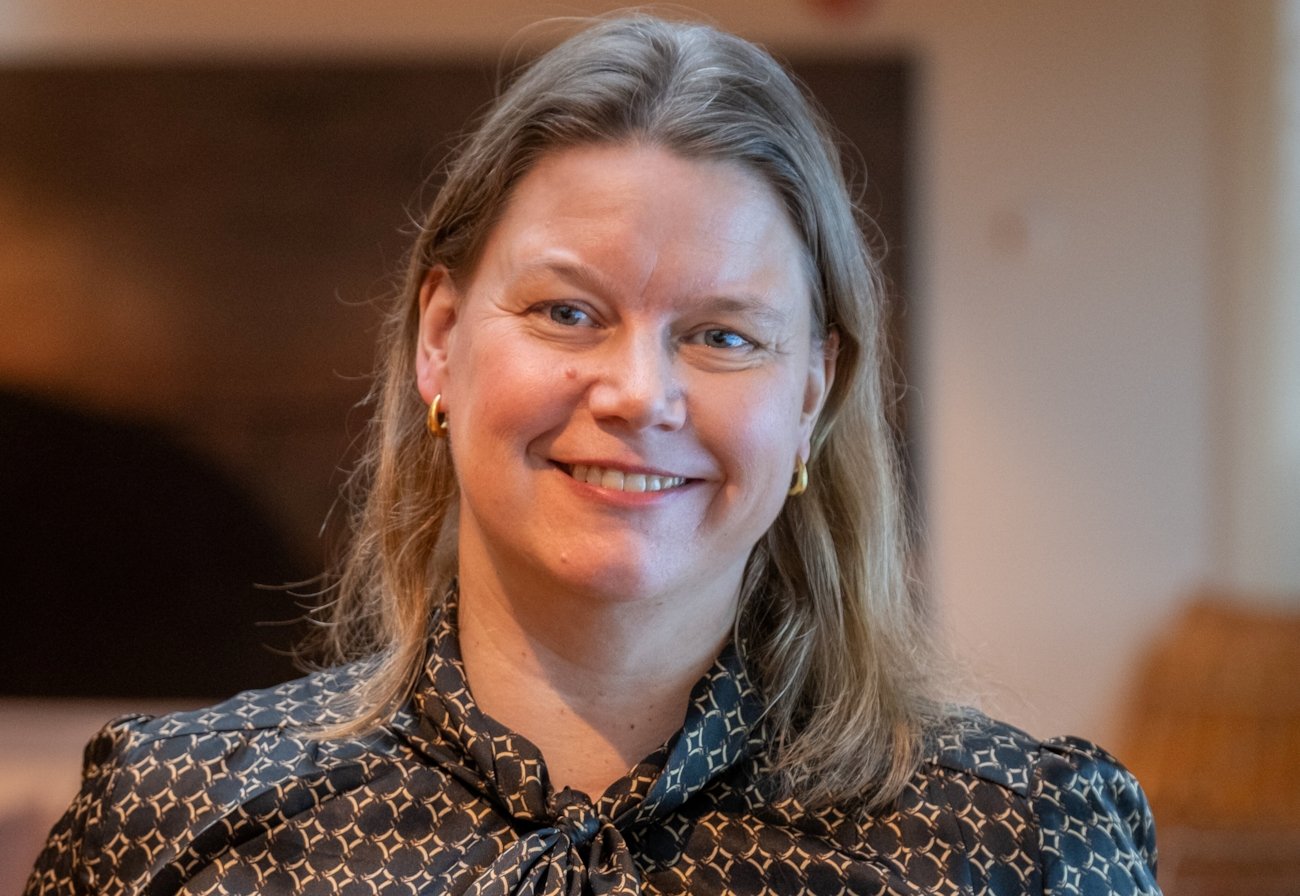 En dame smiler til kamera.